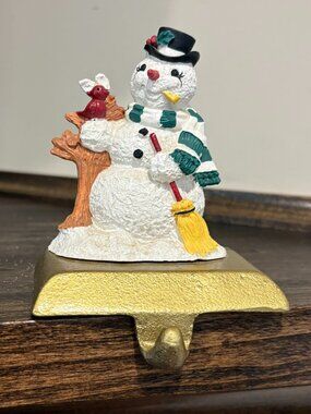 Vintage cast iron stocking holder on a gold base, box, snowman with cardinal